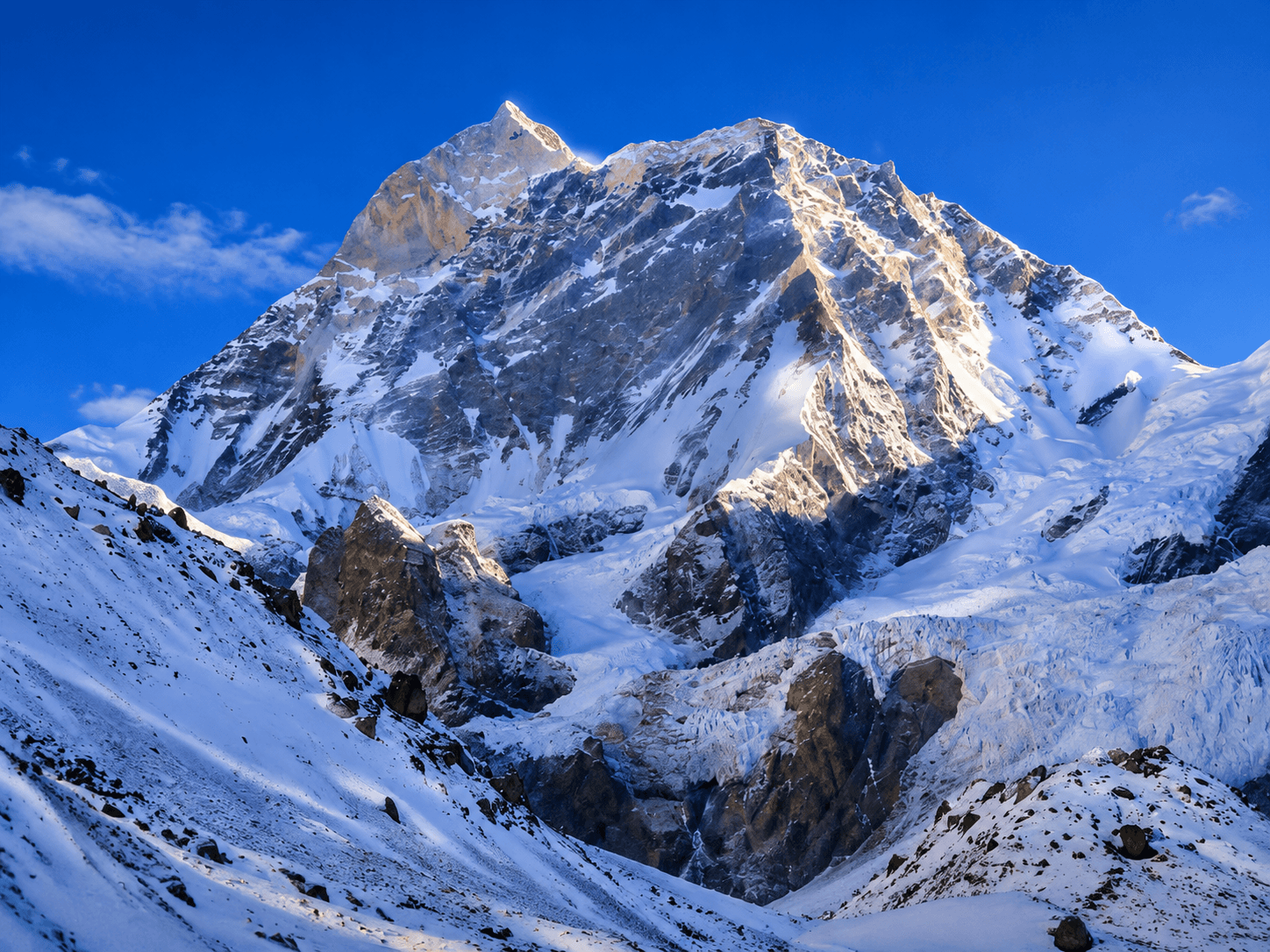 Snow-covered Himalayan mountain peak under a clear blue sky.